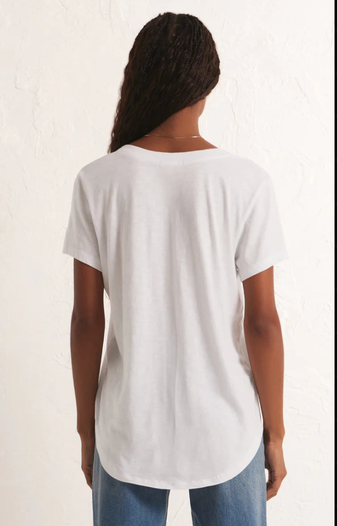 Person wearing a plain white t-shirt on a light background