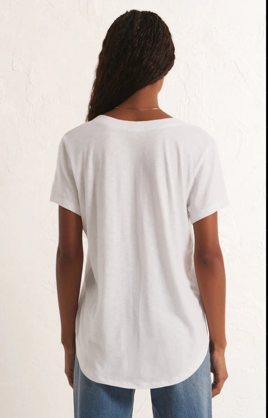 Person wearing a plain white t-shirt on a light background