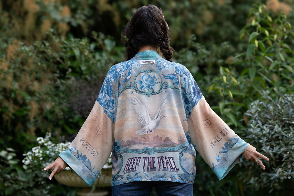 cropped kimono blue colors with dove on back and words Keep The Peace